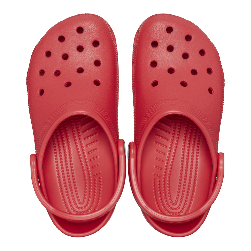 Pair of Crocs clogs in red with holes and stimulation nibs on footbed