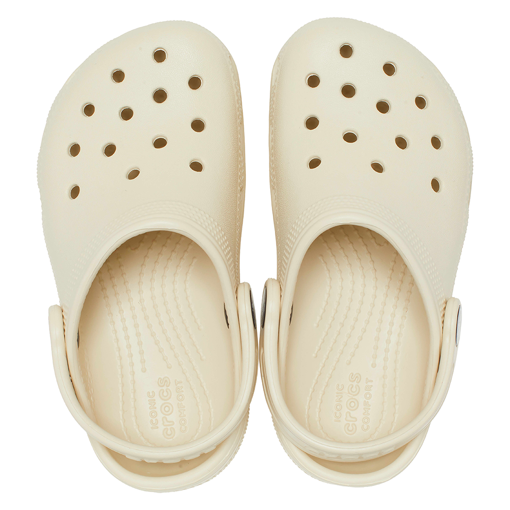 Top down view of pair of Crocs classic bone clogs with holes and straps in sports mode